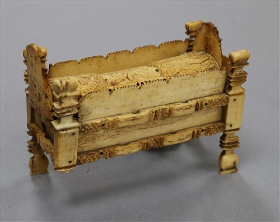 An early 19th century Napoleonic Prisoner of War bone domino set contained in a model crib length 14cm